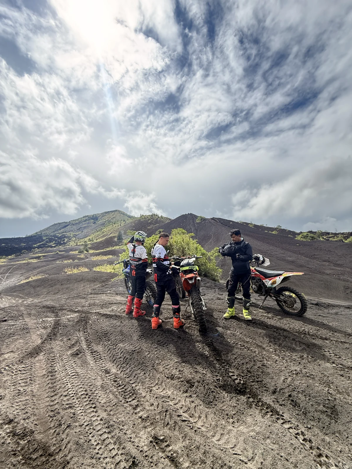 Out on the open slope | Riders and dirt bikes on the black volcanic terrain below Mount Batur, Kintamani, Bali, sober travel adventure.